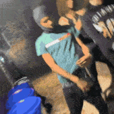 a blurry picture of a man wearing a blue shirt that says ' diamond ' on it