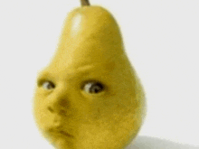 a close up of a pear with a baby 's face on it .