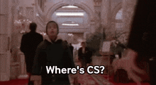 a man walking down a hallway with the words where 's cs written on the bottom