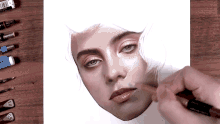a drawing of a woman 's face is being drawn with a pencil with the number 0.5 on it