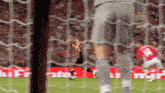 a soccer player with the number 14 on his jersey runs towards the goal