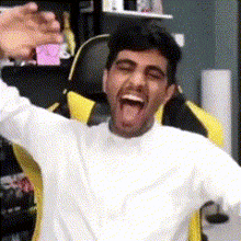 a man in a white shirt is sitting in a yellow and black chair with his mouth open .