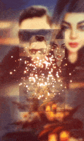 a man and a woman are surrounded by candles