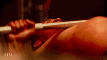 a close up of a man lifting a barbell with the words him behind him