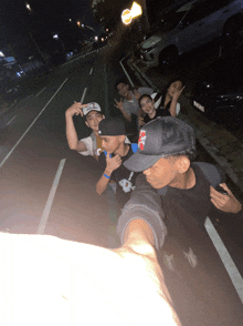 a group of people are posing for a picture with one wearing a hat that says ' i love you '