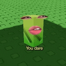 a green cube with a face on it and the words " you dare " below it