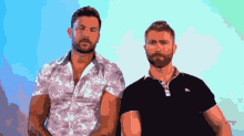 two men are standing next to each other and one is wearing a black shirt with burberry on it