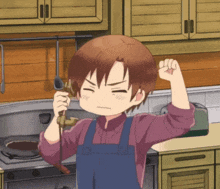 a boy in an apron is holding a spoon in his fist
