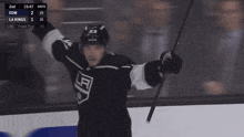 a hockey player in a la kings jersey celebrates
