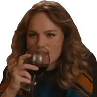 a woman drinking a glass of red wine with her mouth open