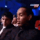 a group of people are watching a boxing match on eurosport live .