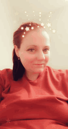 a woman wearing a red shirt with stars on her head