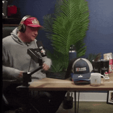 a man wearing headphones and a red hat that says good choice