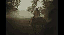 a man in a native american outfit is riding a horse in a field .