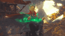 a man in a green jacket is holding a green light in his hand .
