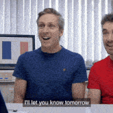 a man in a blue shirt says " i 'll let you know tomorrow " next to another man in a red shirt
