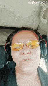 a woman wearing headphones and sunglasses has a starmaker id of 62144653350