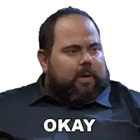 a man with a beard is wearing a shirt with the word okay on it