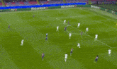 a blurry picture of a soccer player wearing a jersey that says ' hyundai ' on it