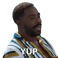 a man with a beard is wearing a sweater that says yup on it