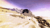 a car is flying through the air over a desert landscape