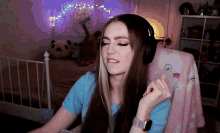 a woman wearing headphones is sitting in front of a computer
