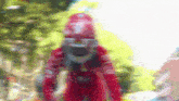 a blurry picture of a person wearing a red helmet and a red jacket