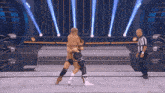 two wrestlers are wrestling in a ring with a referee in the background