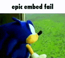 a sonic the hedgehog stuffed animal is sitting in the grass with the words epic embed fail above it .