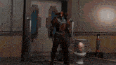 a robot is standing next to another robot laying on the floor