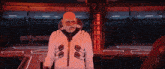 a man with a beard and a white jacket with a s on it