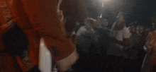 a blurry picture of a man playing a guitar in front of a crowd