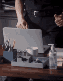 a police officer stands in front of a laptop on a desk