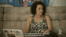 a woman sits on a couch with a laptop and says " you know i m picking all white dudes right now