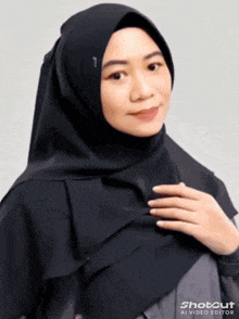 a woman wearing a black hijab has shotcut ai video editor written on the bottom right