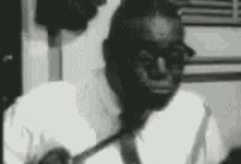 a black and white photo of a man with glasses