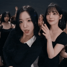 a group of young women are posing for a picture and one of them has a ring on her finger