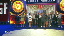 a group of people standing in front of a sign that says grande fratelli