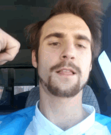 a man with a beard is wearing a blue and white jersey