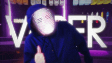 a person wearing a mask giving a thumbs up in front of a sign that says ver