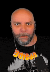 a bald man with a beard is wearing a shirt that says archery on it