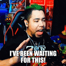 a man with green hair says " i 've been waiting for this " while sitting in a chair