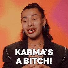 a man says karma 's a bitch while wearing a black jacket