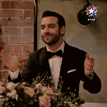 a man in a tuxedo with a star on the bottom right