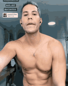 a shirtless man taking a selfie in a bathroom with a sticker that says sportsworldmex