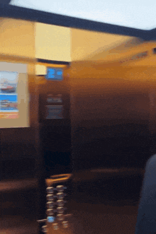 a blurred image of an elevator with a blue sign that says ' elevator ' on it
