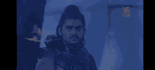a man with long hair and a beard is holding a sword in his hand .