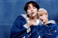 a man in a blue jacket is holding another man 's hand