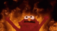 elmo from sesame street is on fire with his arms outstretched in front of a fire .