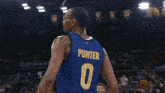 a basketball player stands in front of a scoreboard that shows the time as 9:39